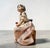 “lolita” porcelain figurine, model no. 5372, designed by salvador debón for lladró, spain. the figure depicts a seated...