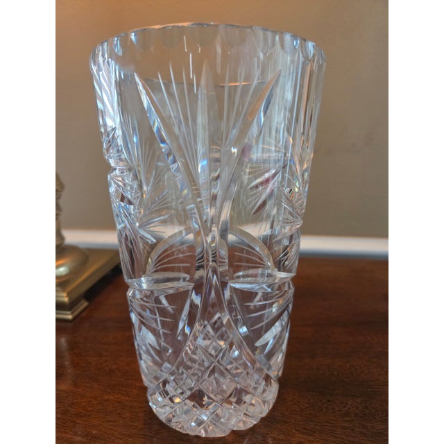 Dazzling hand cut crystal vase in a richly ornamented, swirling, pin wheel like design by a virtuoso glass-maker. Crystal...