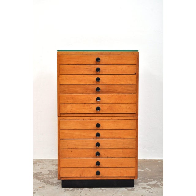 Beautiful beechwood chest of drawers. This heavy, solid school drawer cabinet from the 1950s has 12 drawers and brings a...