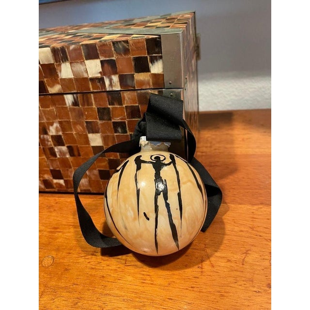 This ornament is hand painted in Shearer’s typical drip style. It is signed and dated 2005. This is the only ornament he...