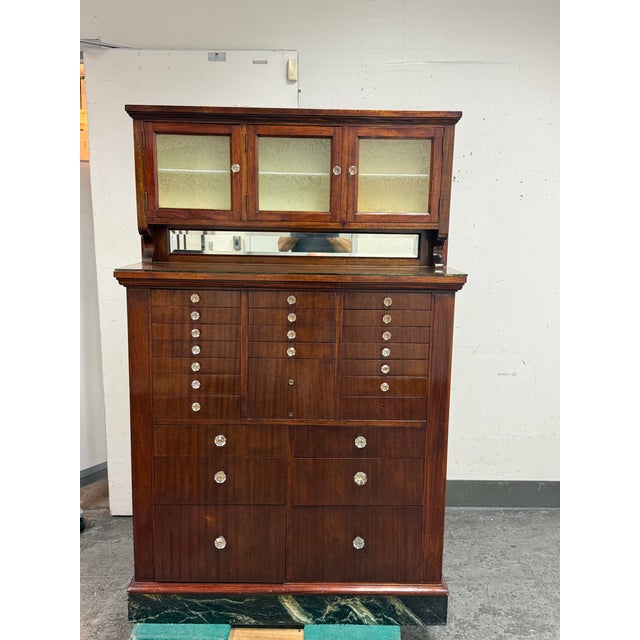 Design Plus Gallery presents an Antique Mahogany Apothecary Dentist Cabinet from the American Cabinet Company. This...