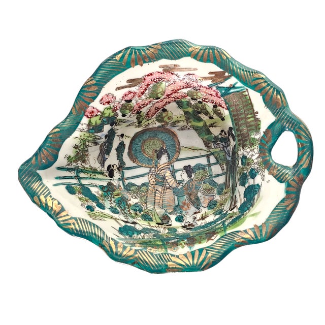 Dating to the late Meiji to early Taishō period (circa 1900–1920), this Japanese hand-painted bowl reflects the export...