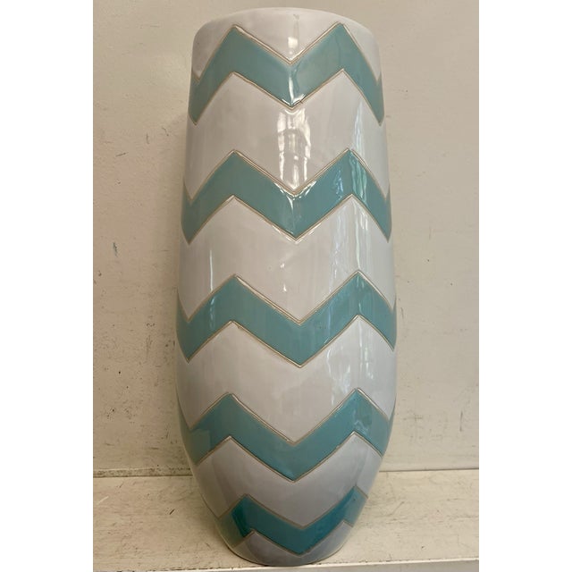Make a bold statement with this stunning vintage ceramic floor vase featuring a striking teal and white zigzag pattern....