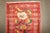 a mid 20th century Turkish Rug with a floral pattern on a red field