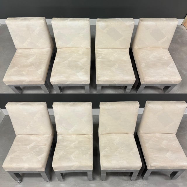 A set of 8 chrome patchwork dining chairs designed by Paul Evans for Directional. Some tears and discoloration in fabric....