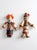 A pair of mid century scandinavian folk art wall hangings featuring articulated wooden limbs and hand-painted traditional...