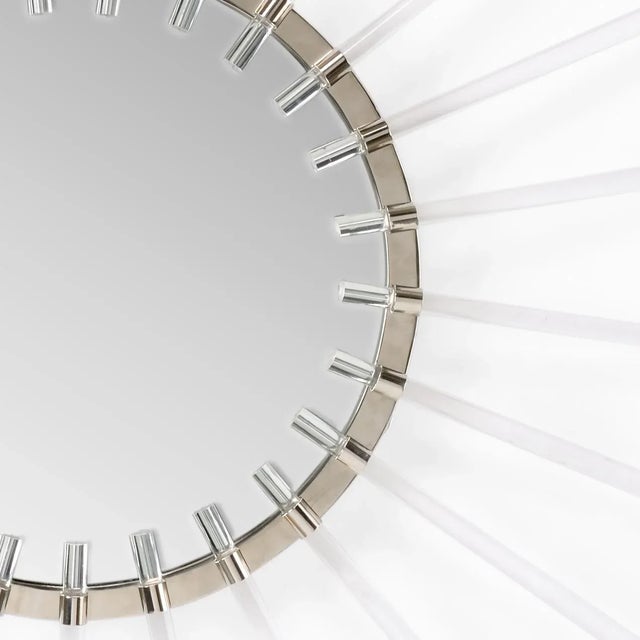 The classic sunburst shaped mirror has taken on a modern style with lucite bursts and polished nickel finish. Adriana...