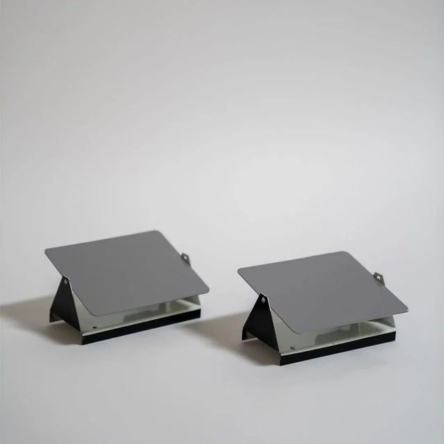 The iconic enameled wall lights by Charlotte Perriand from the 1960’s designed for the apartments of the ski resort Les...