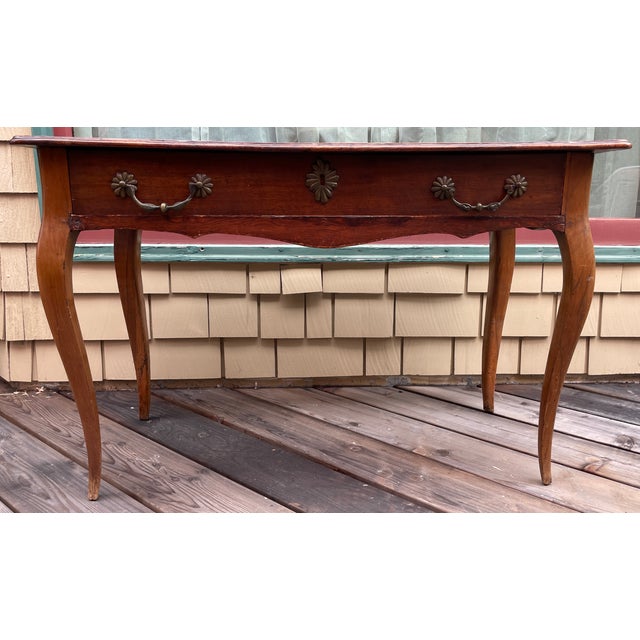 The rectangular top is made with 2 wide planks, extended and rounded front corners, and a subtle molded edge around three...