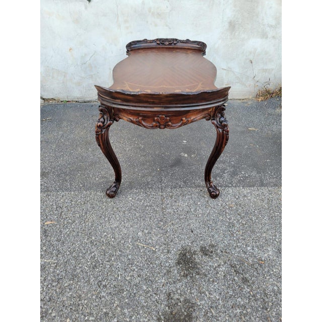 This exquisite 1930s Italian coffee table, crafted from rich beechwood, showcases stunning hand-carved detailing and...