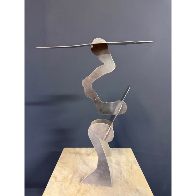 “The Test” by William Dickey King is a dynamic modernist figural sculpture executed in hand-cut aluminum and mounted on a...