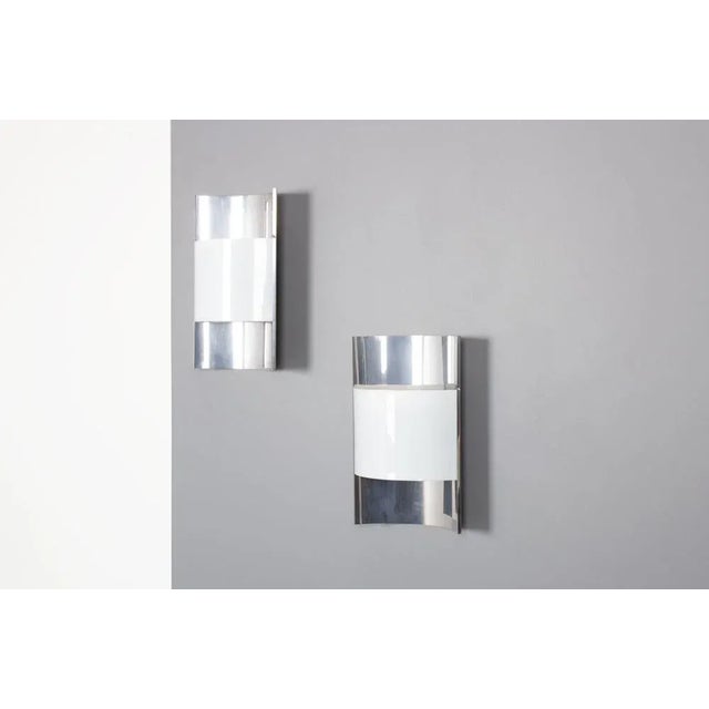 Set of 2 wall lamps edited by Stilux in Italy in the 70s Curved aluminum sheet, white acrylic glass as a reflector Some...