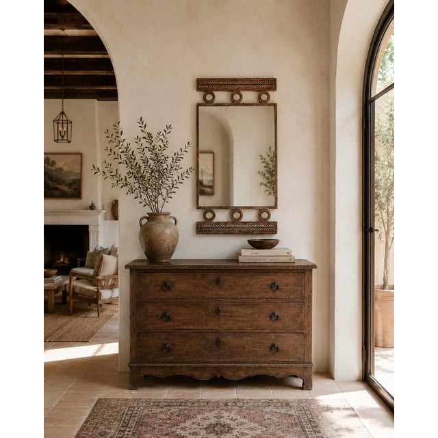 Crafted from steel and finished in a richly distressed copper-bronze patina, this vintage wall mirror is framed top and...