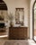 Crafted from steel and finished in a richly distressed copper-bronze patina, this vintage wall mirror is framed top and...