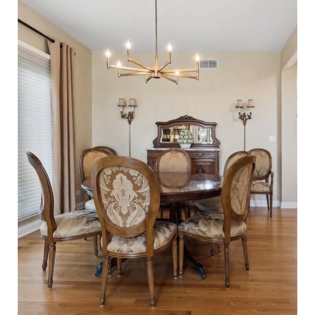 The Theodore Alexander Large Round Mahogany Dining Extension Table is a stunning piece of furniture designed for the...