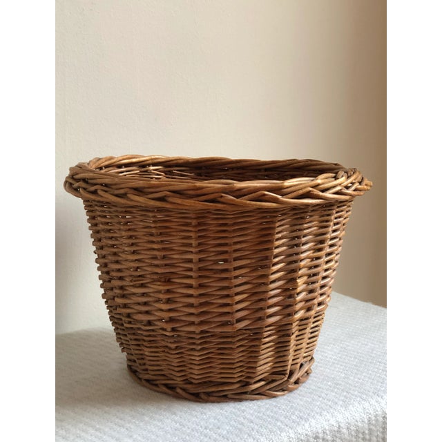 Offering a beautiful mid-20th century wicker planter basket with pretty French randing and a warm, rich patina that can...