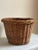 Offering a beautiful mid-20th century wicker planter basket with pretty French randing and a warm, rich patina that can...