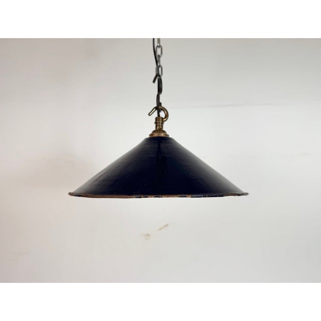 Industrial dark blue enamel factory pendant light made in United Kingdom during the 1950s. White enamel inside the shade....