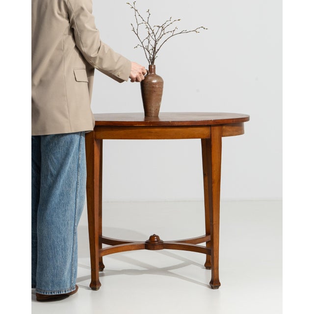 A circa 1900 French side table in the Sheraton Revival style, featuring a rectangular top and a structured frame with...