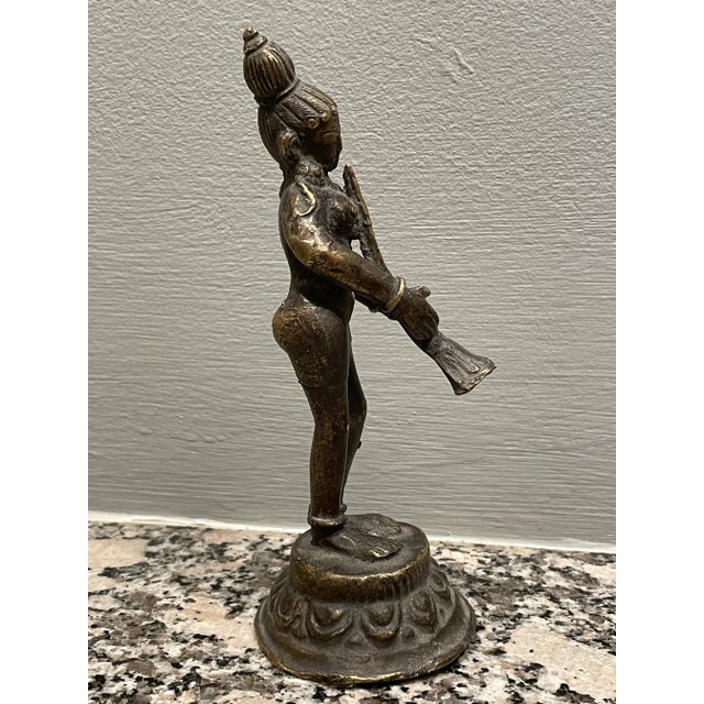 A Hindu devotee or Gopi of brass playing a shenai.