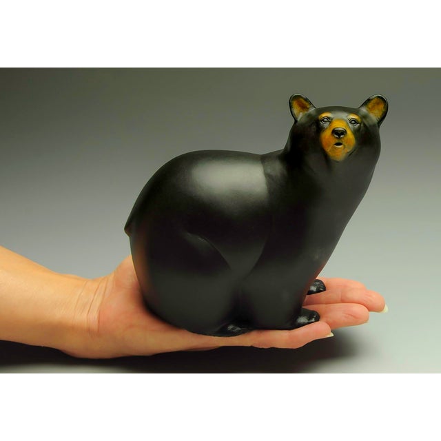 Bear Handed by Jeremy Bradshaw | Bronze sculpture of a black bear in a hand. For Sale