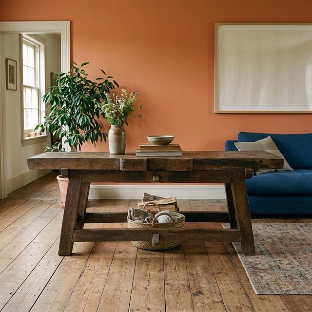 A beautifully aged antique European work table crafted from solid pine, featuring a substantial plank top with a rich,...