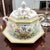 A hand-painted Italian porcelain soup tureen set, executed in an octagonal form with crisp faceting and traditional gilt...