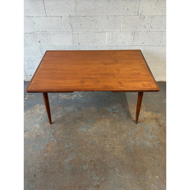 An original 1950's teak and oak dining table by Hans Wegner for Andreas Tuck, this AT-312 table features the highest...