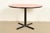 A sleek and stylish Modern or Mid-Century Modern round dining table, breakfast table, bistro table, or game table In the...