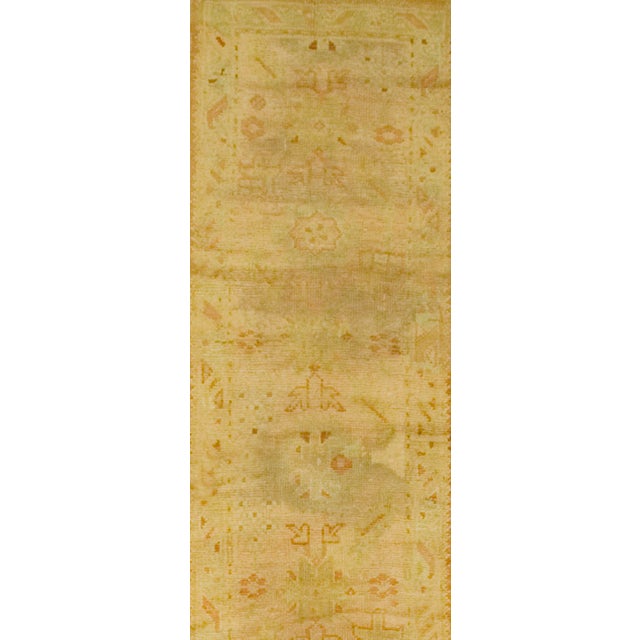 This antique Oushak hand knotted runner circa 1890 from Turkey portrays a beautiful color balance. The carpet has been...