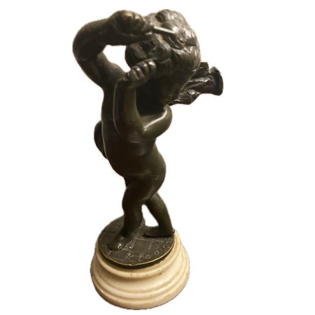 This is a 19th-century French patinated bronze musical cherub or putto sculpture after Claude Michel Clodion, featuring...