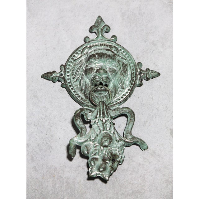 This cast iron door knocker has an amazing patina, and I will guess it is cast iron as it strongly attracts a magnet. It...