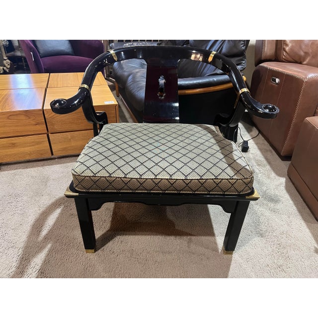 Iconic James Mont Asian style chair featuring a dramatic horseshoe back, black lacquer finish, and gilt accents....