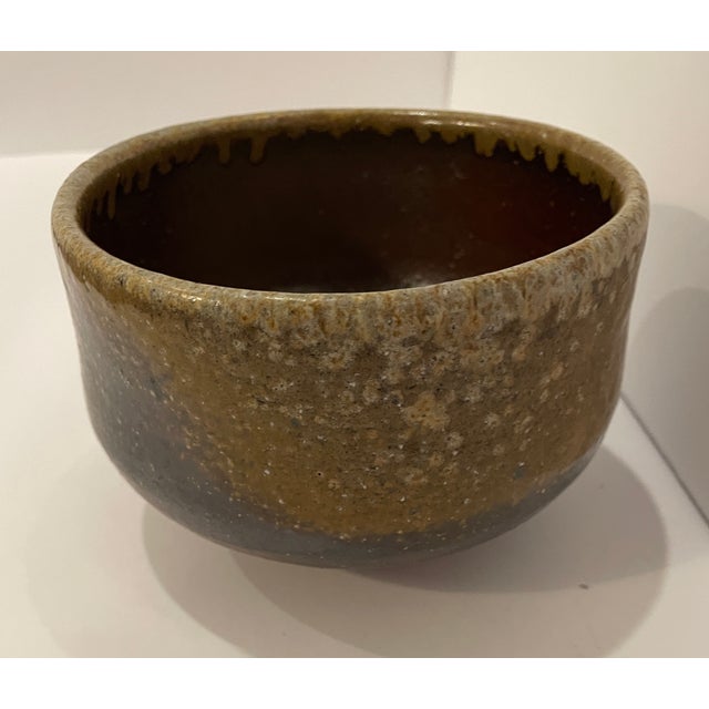 Asian glazed pottery tea bowl. Signed on the bottom.