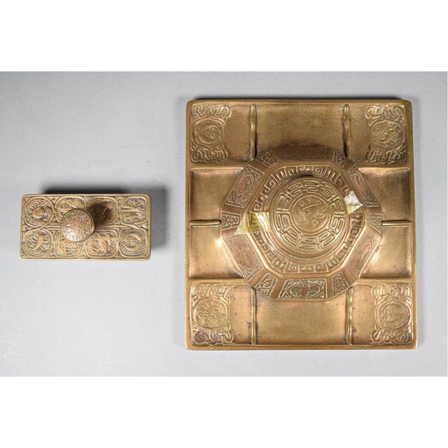 A highly collectible Tiffany Studios New York desk set including the Zodiac inkwell with attached pen tray and matching...