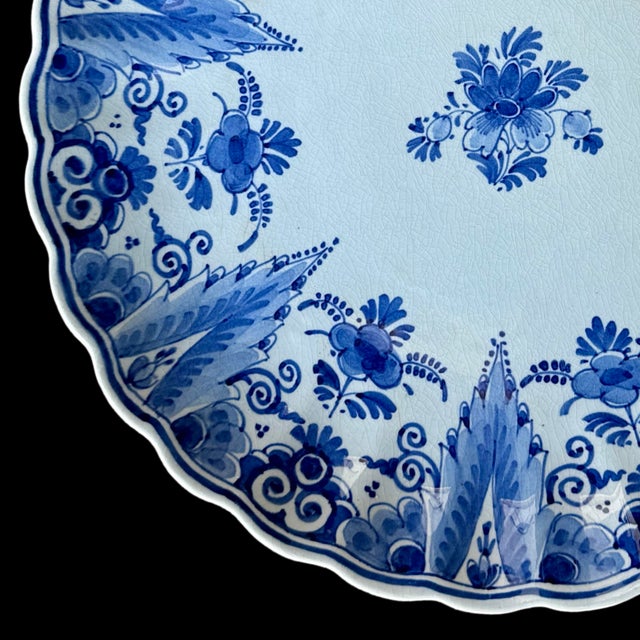 Crafted in Delft, Netherlands, this exquisite vintage Royal Delft Blue Lobed Dish showcases the timeless beauty of Dutch...