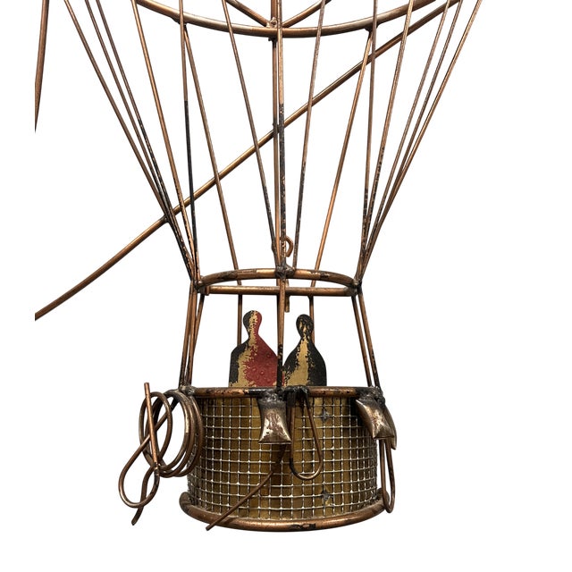 This hot air balloon wall sculpture by Curtis Jere is made of welded brass components. it depicts two people operating a...