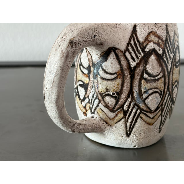 The Rügen stamp on the mug indicates Rügen Keramik. The mug is 14 cm wide including the handle, and the mug itself is...