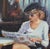 Original oil painting by Sean Wu, Parisian Pause, A modern woman sits in a coffee shop reading the morning paper.