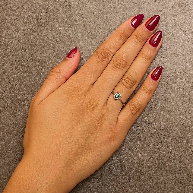 Elegant and radiant, this exquisite ring is a symphony of color and light, masterfully crafted from rhodium-plated 10K...