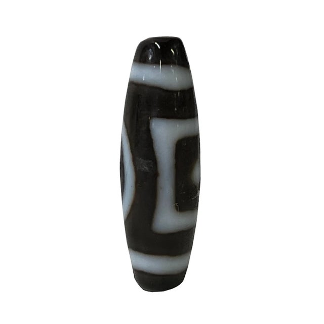 This is a nicely handmade natural agate stone Dzi bead with a brownish geometric pattern on the oval shape body. Dzi bead...
