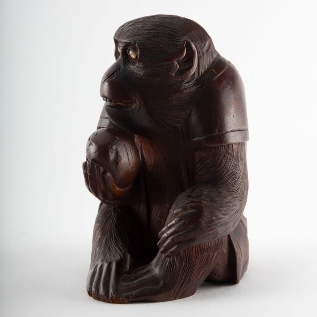 Early 20th Century Japanese Carved Wood Figure of a Monkey: A finely carved Japanese wood netsuke depicting a seated...