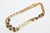 This classic and forever Chanel long necklace has knots in a darker gold plated Gilt metal with a lighter gold plated gilt...