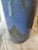 This object is an old cartridge case that has been transformed into a vase. This transformation of military objects into...