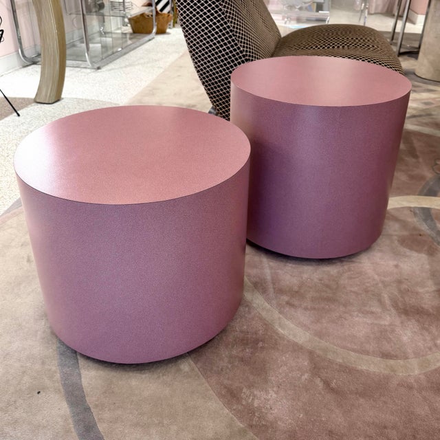 A wonderful pair of mauve colored rolling drum laminate side tables. One is 2" taller than the other, both have the same...