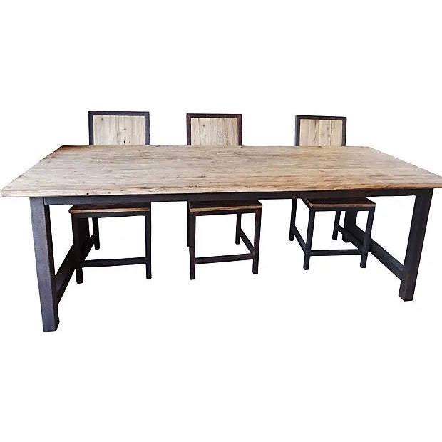 Wood and iron dining table with six chairs. Chairs : 38"H x 17.5"W x 18"L. Holes in the wood, rust. Table : 86" L x 35" W...