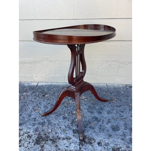 Constructed in the 1920’s-1930’s, this mersman occasional table features a surfboard top which sits on a lyre base. The...