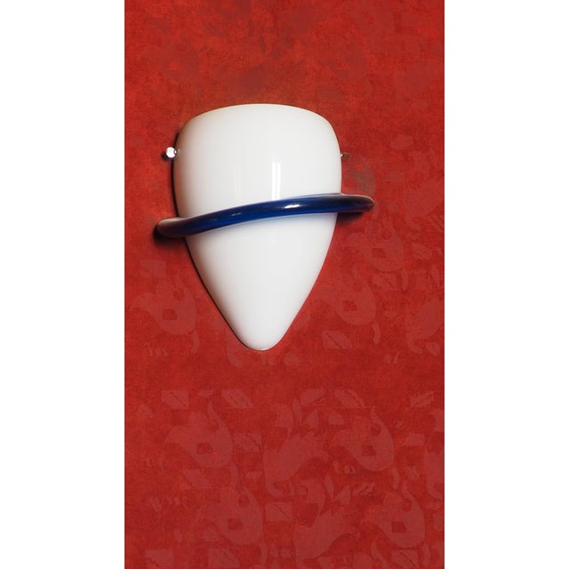 N 8 wall lamps in milky white blown glass with an applied ring in cobalt blue glass. This piece has an attribution mark, I...