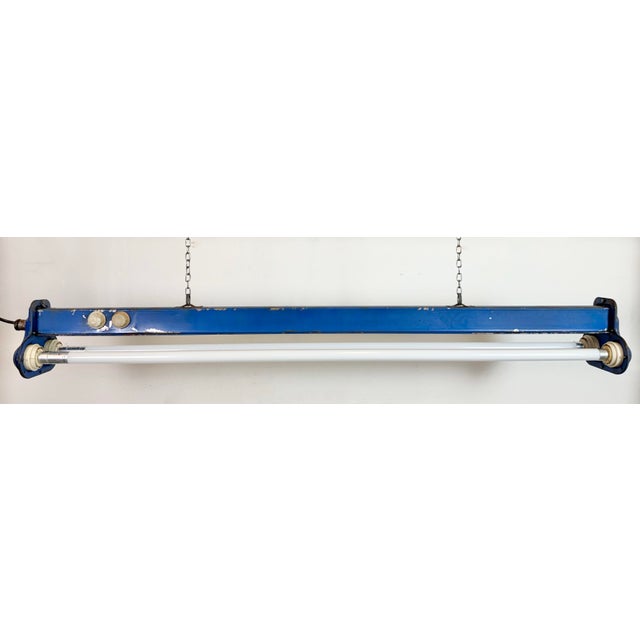 This industrial tube light was made by msi gwarancja olsztyn in poland during the 1970s. It is made of iron and an...