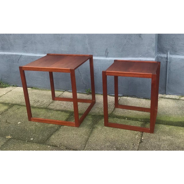 Stackable set of two side tables in solid teak. Quadratic frames. Designed and manufactured in Denmark during the 1960s in...